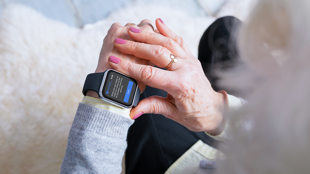 ci_Oxford PR Woman looking at wearable medical smart watch device on her arm.