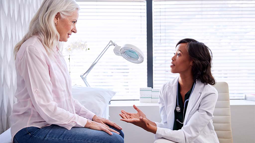 Doctor talking to a patient in a consulting room.