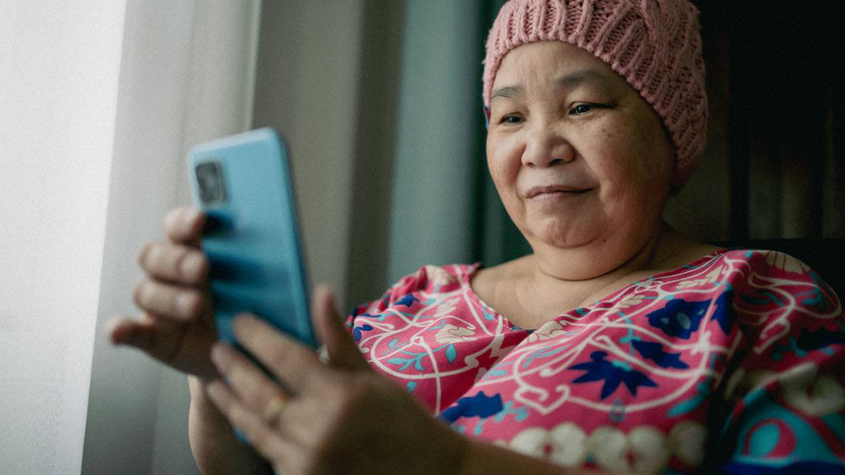 A woman at her home monitoring her health through the Clinical ink application.